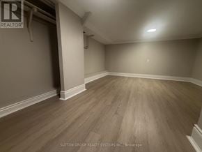 Toronto (Mount Dennis) apartment for rent - A room with wooden flooring and a white ceiling.
