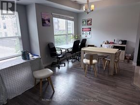 Waterloo townhouse for rent - A room with a table, chairs, and a window.