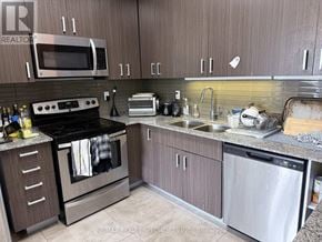 Waterloo townhouse for rent - A kitchen with a stove, oven, dishwasher, and microwave.