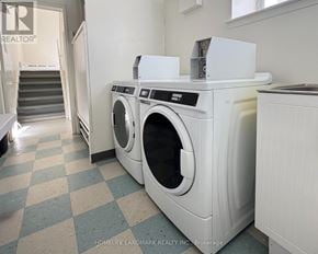 Toronto (Bathurst Manor) triplex for rent - A white washing machine in a laundry room.