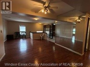 Windsor apartment for rent - A spacious room with a ceiling fan and sliding glass doors.