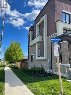 Oshawa (Samac) townhouse for rent - A sign on a post in front of a building that says "Heathrow Park".