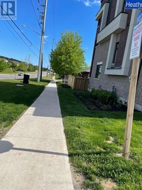 Oshawa (Samac) townhouse for rent - A sidewalk in front of a house with a sign that says "For Sale".
