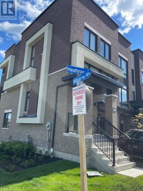 Oshawa (Samac) townhouse for rent - A brown building with a sign that says "Heathrow and N11th".