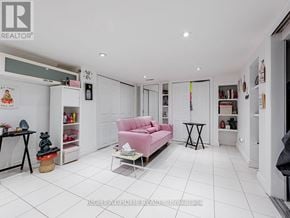 Toronto (Little Portugal) apartment for rent - A living room with a pink sofa and a small table.