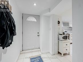 Toronto (Little Portugal) apartment for rent - A white door is in a hallway with a sign on the floor.