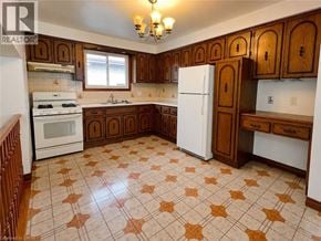 Hamilton apartment for rent - A kitchen with brown cabinets and a white refrigerator.