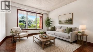 Hamilton apartment for rent - A living room with a couch, chair, and a table with a lamp on it.