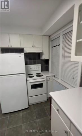 Toronto (Pleasant View) apartment for rent - A white kitchen with a refrigerator, oven, and microwave.