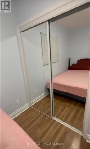 Toronto (Pleasant View) apartment for rent - A bedroom with a pink bed and a mirror on the wall.
