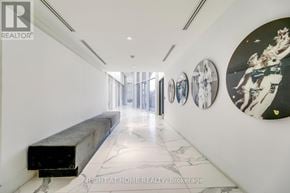 Vaughan (Concord) condo for rent - A hallway with a bench and pictures on the wall.