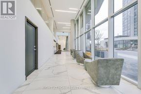 Vaughan (Concord) condo for rent - A hallway with marble floors and large windows.