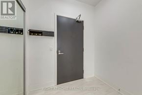 Vaughan (Concord) condo for rent - A room with a door and a brokerage sign on the wall.