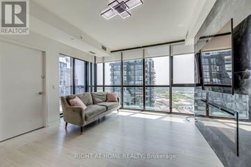 Vaughan (Concord) condo for rent - A spacious living room with a couch and a large window overlooking the city.