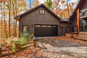 Oro-Medonte apartment for rent - A house with a garage and a driveway covered in leaves.