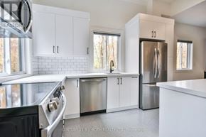 Oro-Medonte apartment for rent - A modern kitchen with white cabinets and stainless steel appliances.