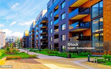 Athens apartment for rent - A modern apartment complex with a wooden walkway in front.