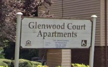 Eden apartment for rent - A sign for Glenwood Court Apartments is displayed in front of a building.