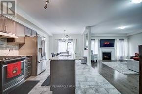 Cambridge apartment for rent - A modern kitchen with a refrigerator, oven, and a dining table.