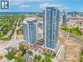 Kitchener condo for rent - A modern high-rise building is under construction in a city.