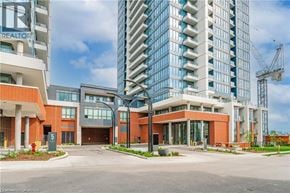 Kitchener condo for rent - A modern building with a glass facade stands tall in the background.