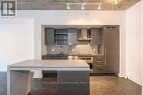 Toronto (Niagara) condo for rent - A modern kitchen with a large island in the middle.
