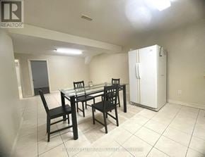 Markham (Milliken Mills East) apartment for rent - A dining room with a table and chairs and a refrigerator in the corner.
