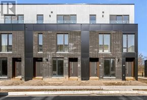 St. Catharines (Oakdale) townhouse for rent - A modern building with a glass facade and a sign that reads "REALTOR".