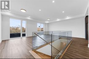 St. Catharines (Oakdale) townhouse for rent - A spacious room with a glass table and wooden flooring.