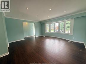 Windsor apartment for rent - A room with wooden floors and a large window.