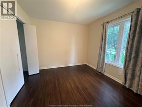 Windsor apartment for rent - A room with wooden flooring and a window with curtains.