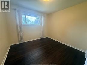 Windsor apartment for rent - A room with wooden flooring and a window with curtains.