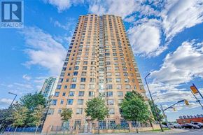Toronto (Bendale) condo for rent - A tall building with a sign that says "REALTOR" on it.