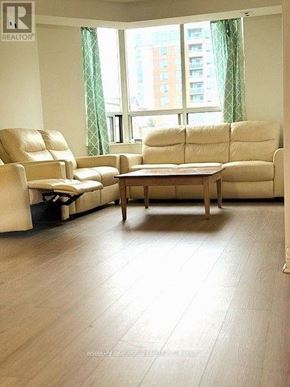 Toronto (Bendale) condo for rent - A living room with a couch, chair, and coffee table.