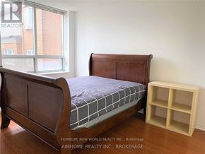 Toronto (Bendale) condo for rent - A bedroom with a bed and a wooden headboard.