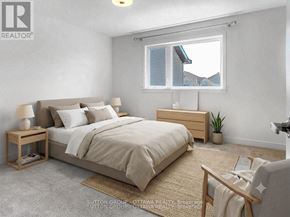 Ottawa townhouse for rent - A bedroom with a large bed, a nightstand, and a window with a view of the roof of a house.