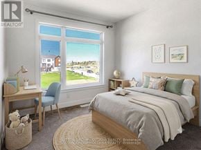 Ottawa townhouse for rent - A bedroom with a large bed, a desk with a chair, and a window with a view of the outside.
