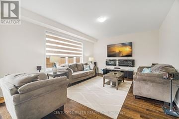 Thorold (Hurricane/Merrittville) apartment for rent - A living room with a grey couch and a painting on the wall.