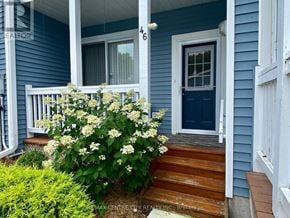 Central Elgin (Port Stanley) townhouse for rent - A blue house with a white door and a wooden staircase leading to the door.