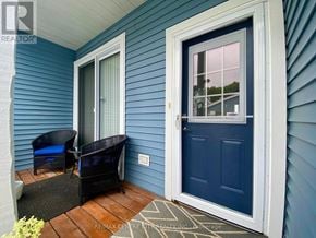 Central Elgin (Port Stanley) townhouse for rent - A blue house with a white door and a small porch.