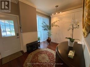 Central Elgin (Port Stanley) townhouse for rent - A living room with a brown table and a white door.