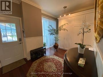 Central Elgin (Port Stanley) townhouse for rent - A living room with a brown table and a white door.