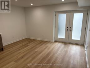 Toronto (Weston-Pellam Park) multi-family for rent - A room with a wooden floor and a white door.