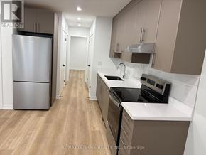 Toronto (Weston-Pellam Park) multi-family for rent - A kitchen with a refrigerator, stove, and oven.