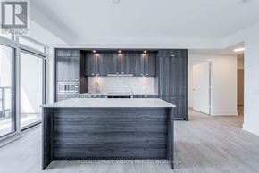 Toronto (Dovercourt-Wallace Emerson-Junction) condo for rent - A modern kitchen with a dark wood countertop and cabinets.