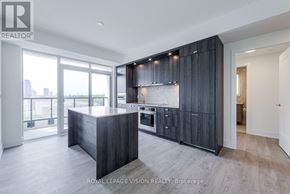 Toronto (Dovercourt-Wallace Emerson-Junction) condo for rent - A modern kitchen with dark wood cabinets and a large island.