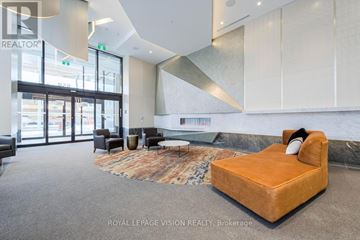 Toronto (Dovercourt-Wallace Emerson-Junction) condo for rent - A living room with a brown rug and a brown chair.