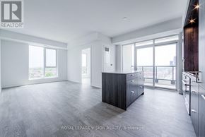 Toronto (Dovercourt-Wallace Emerson-Junction) condo for rent - A spacious, well-lit room with a kitchen area and a large window.