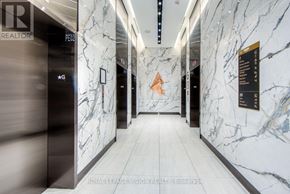 Toronto (Waterfront Communities) condo for rent - A marble hallway with a sign that says "REALTOR".