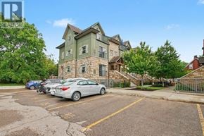 Waterloo townhouse for rent - A parking lot with a car and a building in the background.